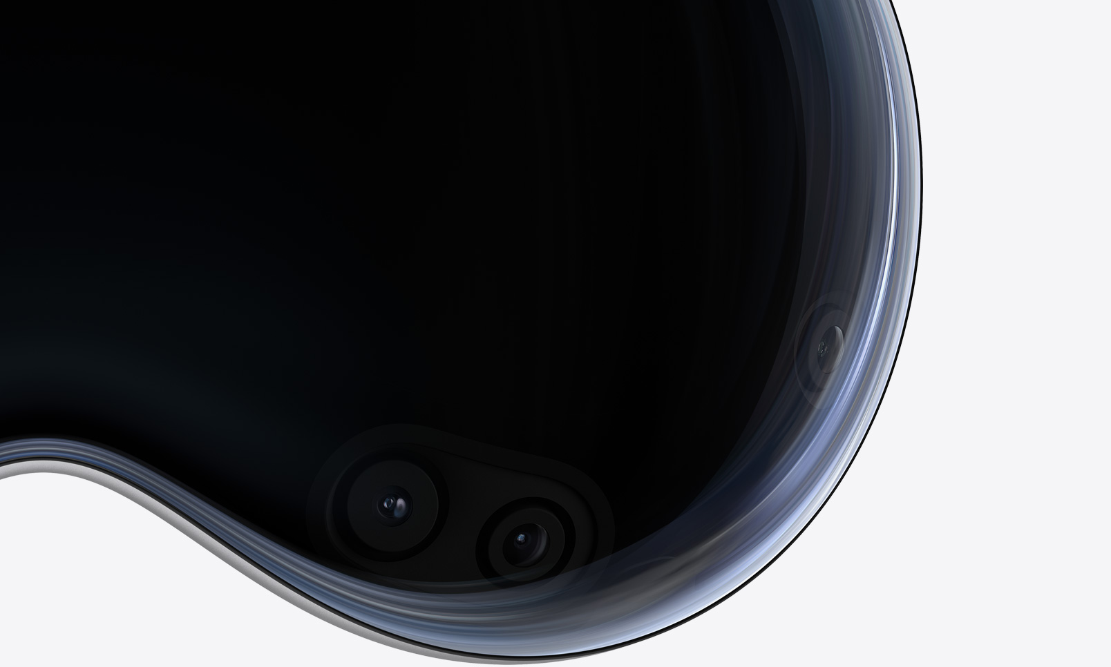 Apple Vision Pro 正面近距离特写,展示弧形玻璃罩后面的摄像头和传感器。