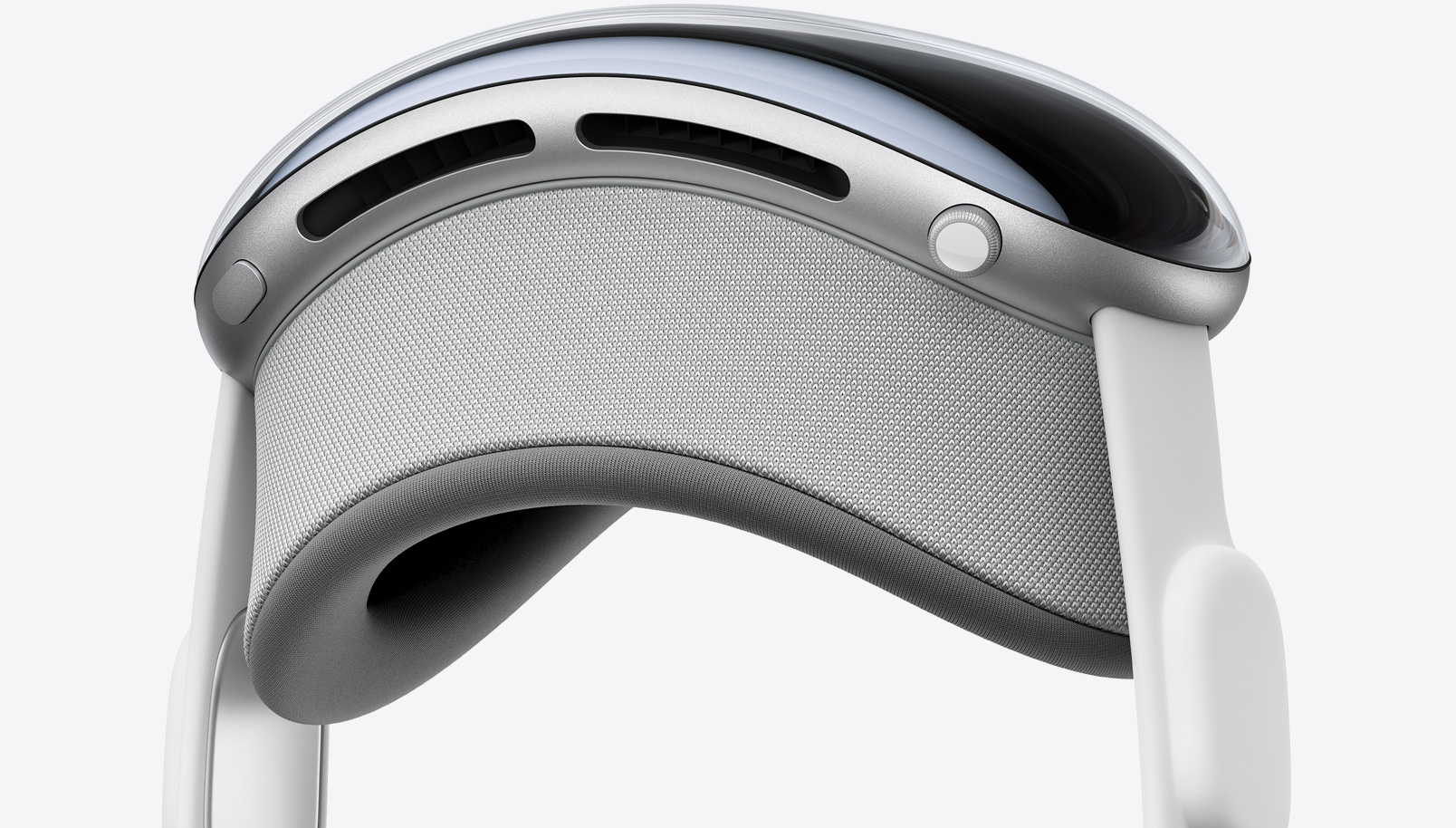 Apple Vision Pro 竖直侧面视图,展示顶部按钮、数码旋钮、遮光罩和音频带。